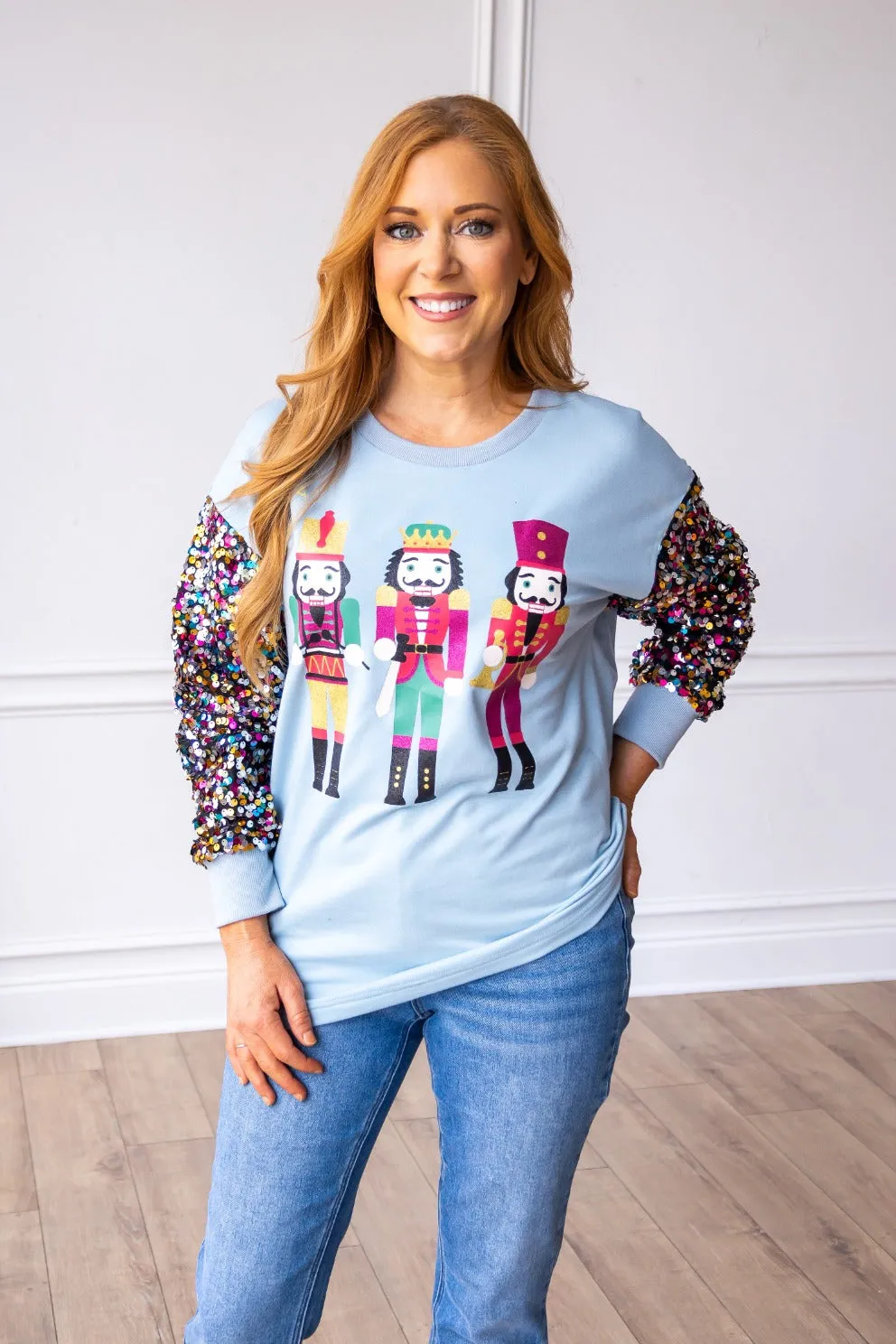 Nutcrackers on Blue Sweatshirt with Sequin Sleeves